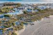 An aerial view showing J'aime la Mer right on the beach.