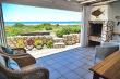 Sit and relax on the patio, watching the beach and waves. 