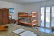 Bunk bed and TV in living area, seen from kitchen