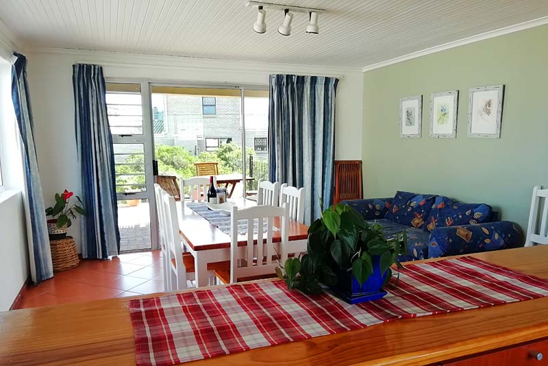 Open-plan kitchen and dining room next to outdoor braai area