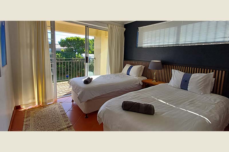 Bottom bedroom with sliding door to verandah. 