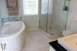 Bath and shower ensuing to main bedroom 