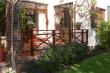 Wisteria - view of patio and French doors from garden.