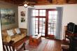 Bitou Valley House lounge area with fireplace and DSTV