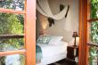 Each bedroom has doors opening to the lush garden.