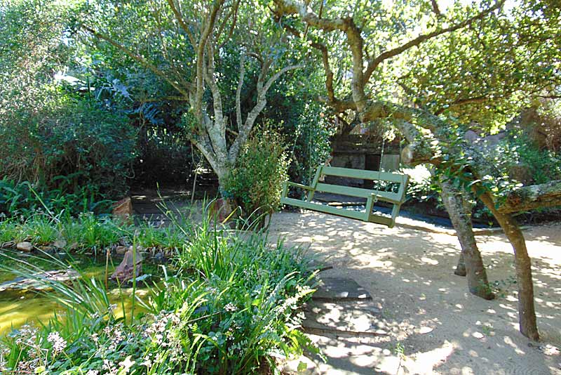 Relax on the swing in the peace of the garden.