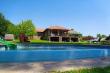 Duck Cottage - Rimflow pool with main house in background