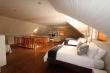 Upstairs lounge with 3 double beds. Offers TV, full DSTV, DVD & free wi-fi.