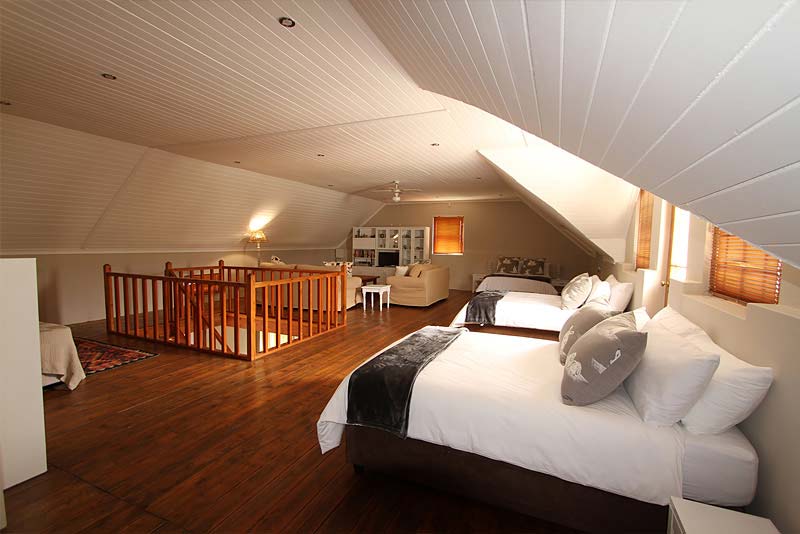 Upstairs lounge with 3 double beds. Offers TV, full DSTV, DVD & free wi-fi.
