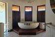 En suite bathroom with bath and shower