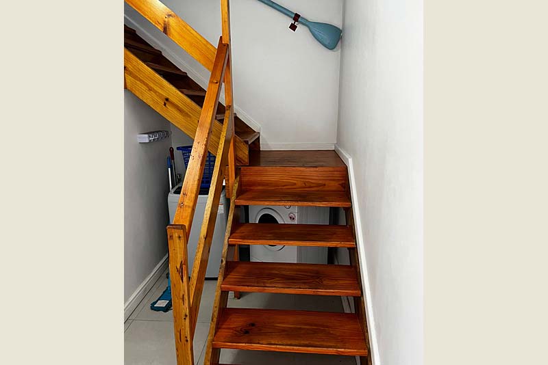 Washing machine/dryer. Stairs leading to deck and loft room