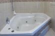 Bathroom 1 with spa bath ensuite to Bedroom 1 top section