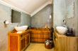 The en-suite bathroom features shower and unique wooden bath