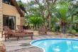 pool area under large thorn trees