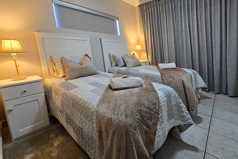 Elegant second bedroom offers 2 single beds and comfort!