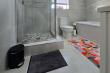 Beautifully textured bath mat gives bathroom a pop of colour