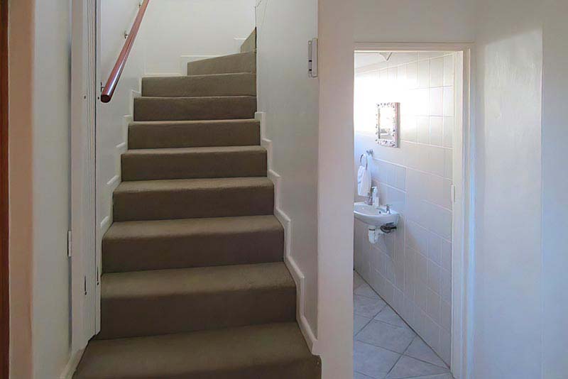 Stairs to bedrooms, and guest toilet
