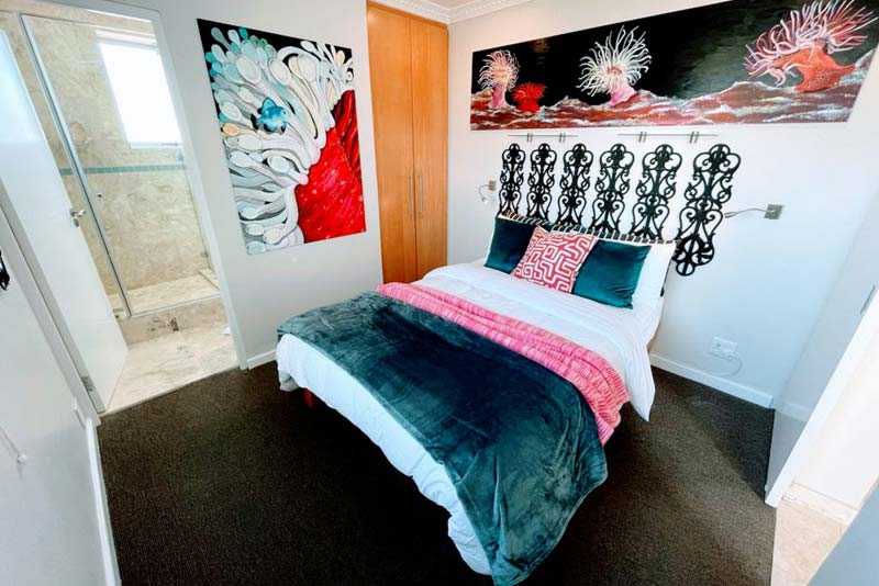 2nd bedroom with artwork by owner.