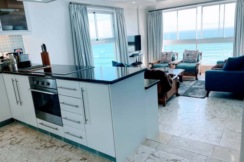 Kitchen slightly elevated with view over ocean.
