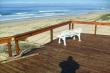 Wooden deck on the pristine beach in front of the cottage
