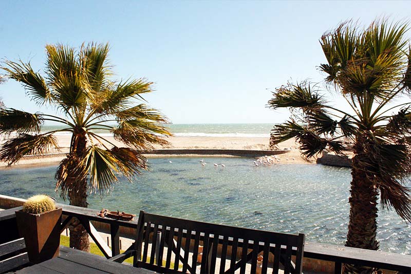 View on water-feature, sea and beach from the deck