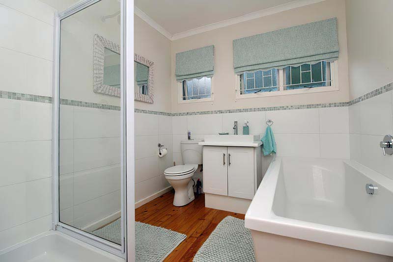 full bathroom with bath, shower and toilet