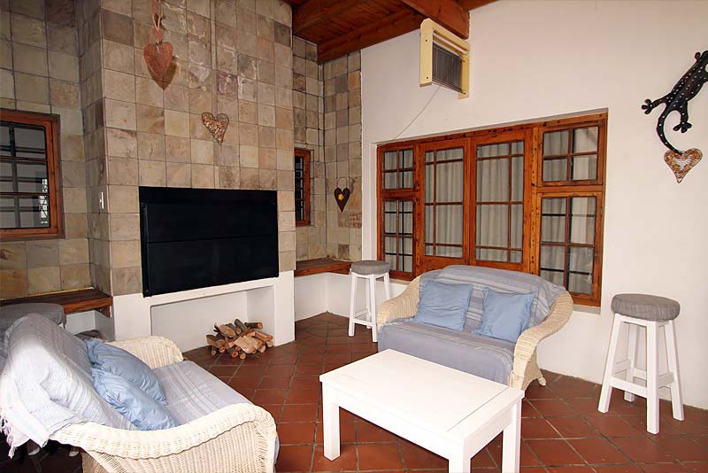 French doors from TV room that open to stoep with braai.
