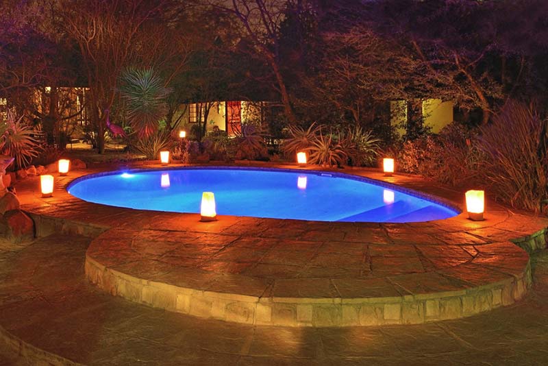 Pool at night with candles